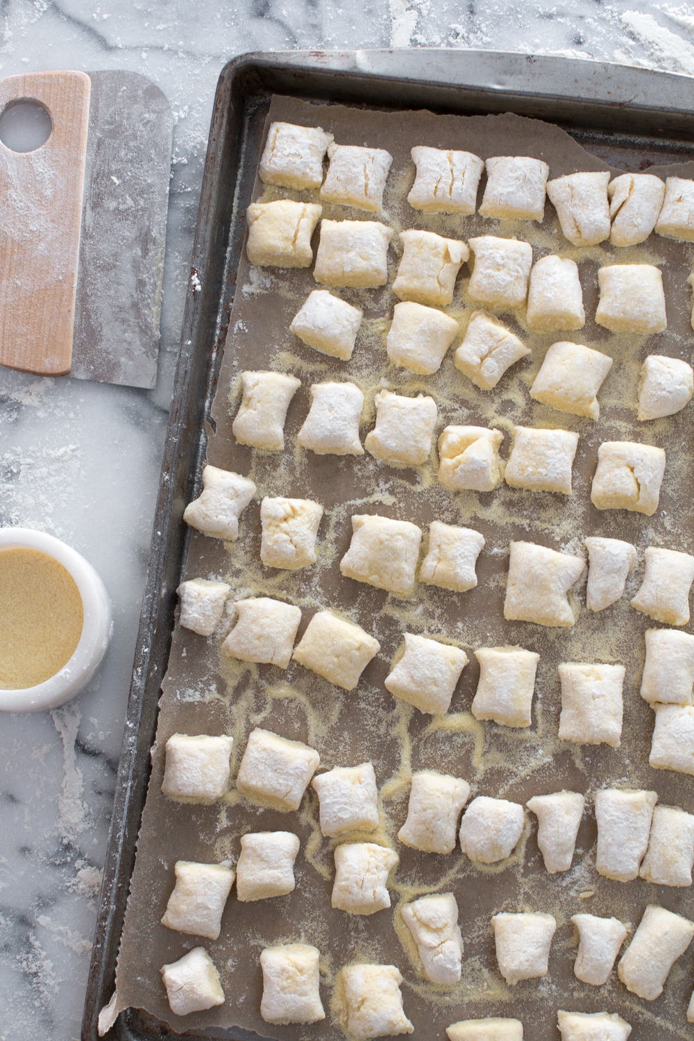 Line up the dunderi on a baking sheet sprinkled lightly with semolina flour to keep from sticking.