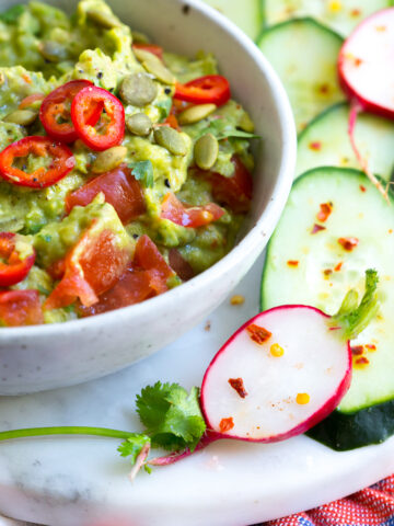 Guacamole with Spicy Cucumbers and Radishes.