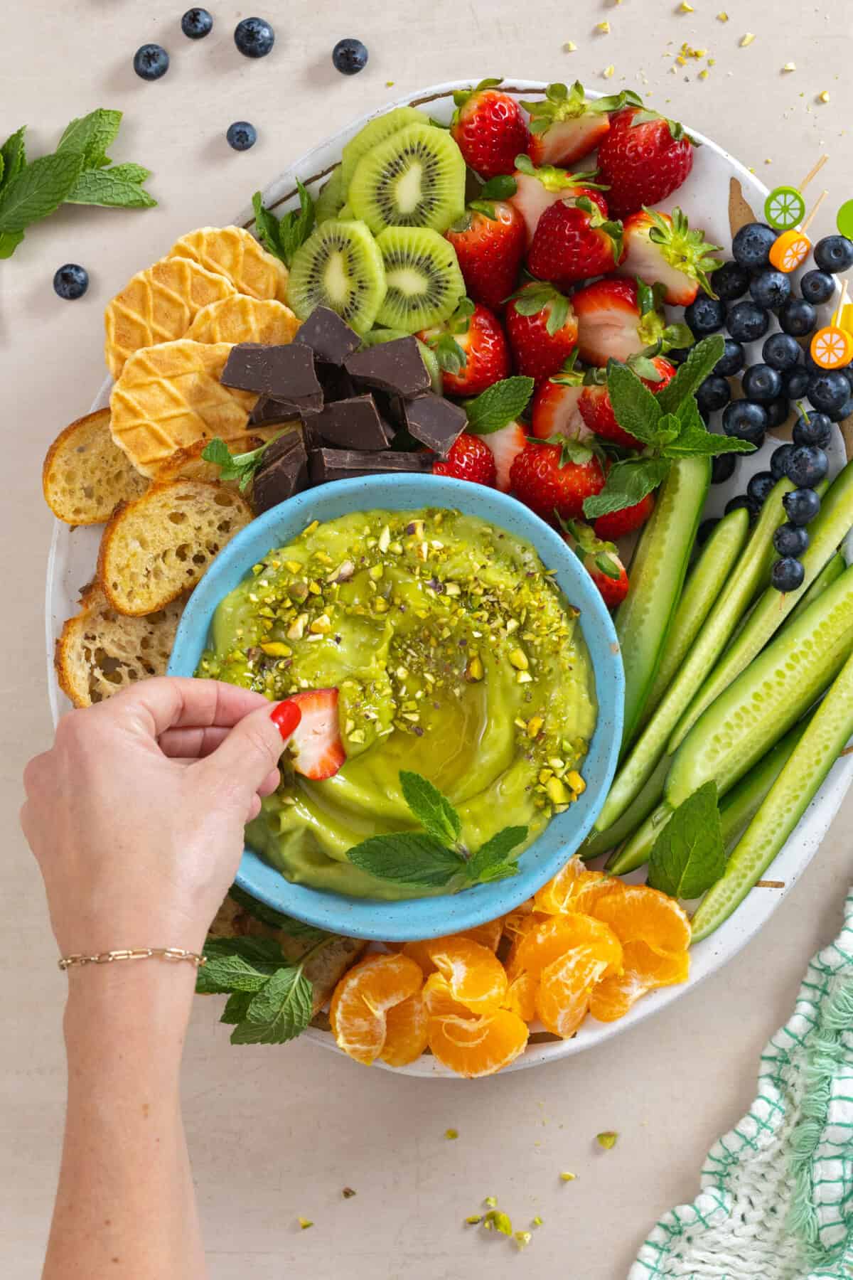 Dipping strawberries into Sweet Avocado Dip