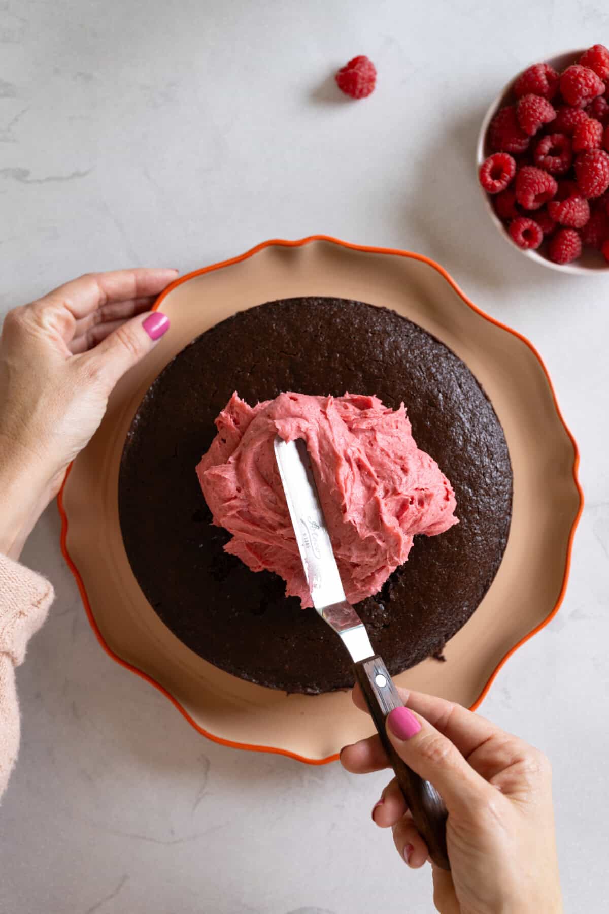 Frosting the Chocolate Cake with Raspberry Cream Cheese Frosting